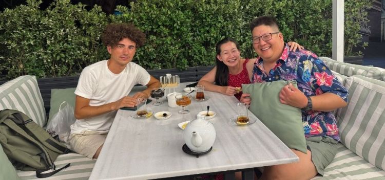 A group posing over Azerbaijani tea with jams and paxlava and shakarbura in our street food tour