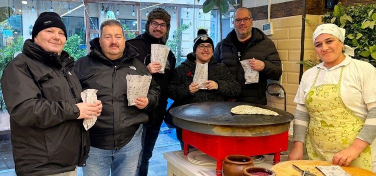 A group just inside of street vendor in our street food tour